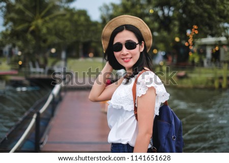Woman traveler enjoying view of dam and mountain during her holiday