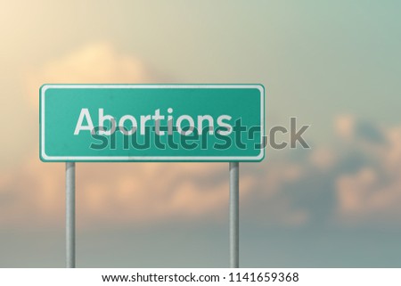 ABORTIONS - green road sign.