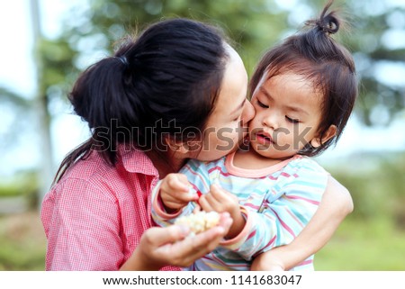 Symbol of love Thailand Mother's day. Give garland flower and jasmine. Asian mom kiss her daughter.