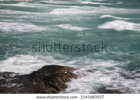 The waves and rocks in the sea, country Thailand during the morning hours.