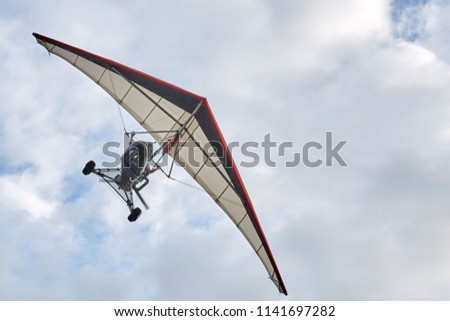 delta wing with engine flying cloudy sky