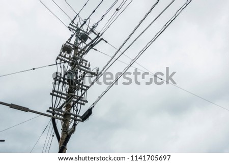 Electricity Pole with Cable Lines and the cloudy sky  backdrop, Power Utilities with Pole in Thailand