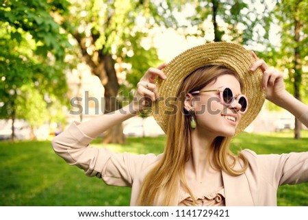  woman in hat with glasses on nature fashion                              