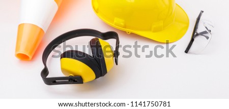 Banner image of a traffic cone and construction safety gear including hard hat, goggles, and earmuffs