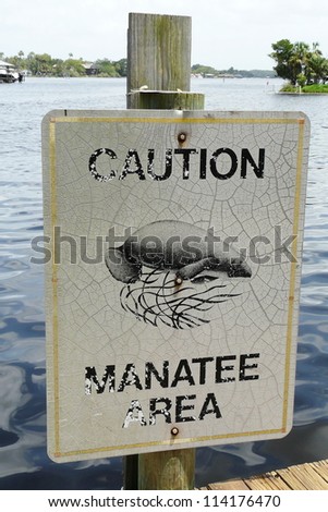 A Manatee Caution sign helps protect the endangered West Indian manatees from motorized boats in the Homosassa River, Florida.