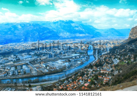 French Grenoble aerial view on sunny spring day. Great blue mountains, top city. Blue toning effect
