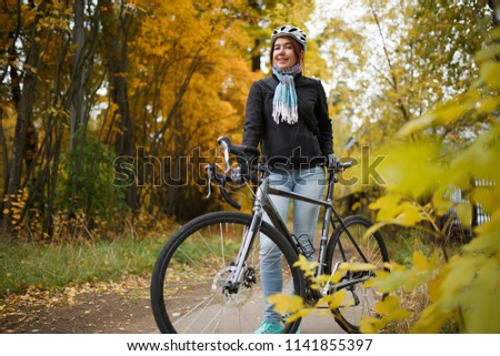 Image of woman with bicycle in helmet