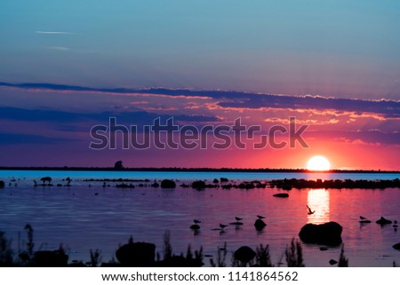 Sunset ocean view with stone in the foreground