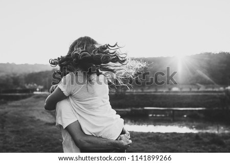 Photo married couple hugging, husband and wife near lake. Close Up. Summer. Portrait of a romantic young man and woman in love in nature. husband and wife on sunlight. Black and white photo.