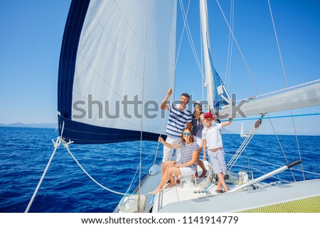 Happy family with adorable daughter and son resting on a big yacht Royalty-Free Stock Photo #1141914779