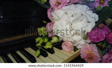 Garden roses. Garden peonies. Garden hydrangea. Garden flowers. Flowers on a piano.