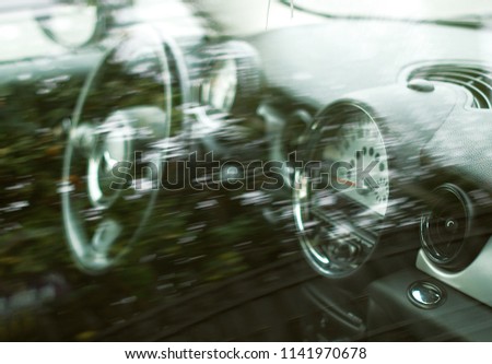 panel and the steering wheel of the car behind the glass. motion, reflection Royalty-Free Stock Photo #1141970678