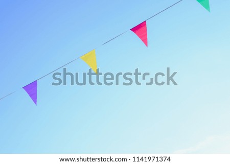 Colorful pennants with sky background to place text