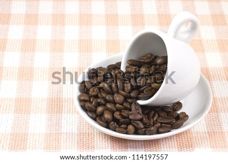 This is a picture of coffee beans and coffee cup.
