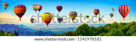 Panorama of mountain with hot air balloons on morning at Thailand. Royalty-Free Stock Photo #1141978181