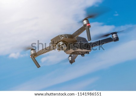 Drone flying high in the sky taking aerial photos