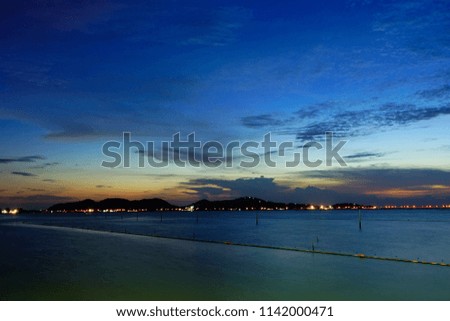 Long exposure shot of Lake view at Southern Thailand on sunset time background,Long exposure shot lake view with colored sky over lake on sunset time background.                 