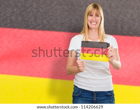 Woman Holding Germany Flag And Standing Against Flag