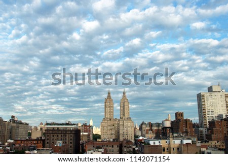 New York City, NY building under a dramatic, cloudy sky