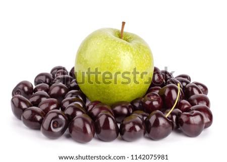 Apple and lots of cherries on a white background isolated close up macro