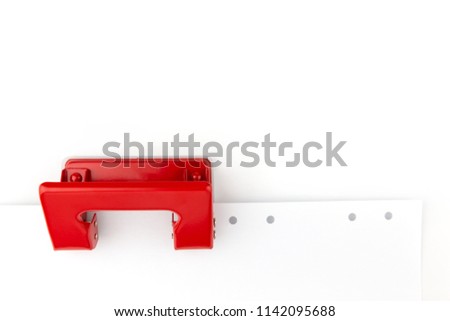 Red paper hole puncher isolated on white background.
