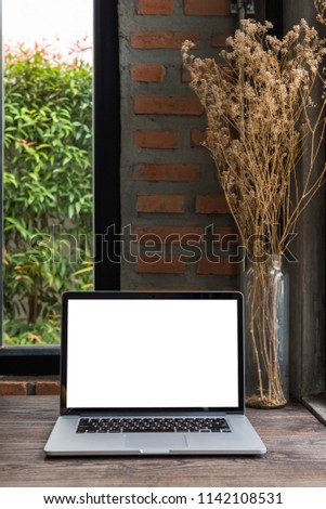 blank screen laptop computer on wooden table, Vertical