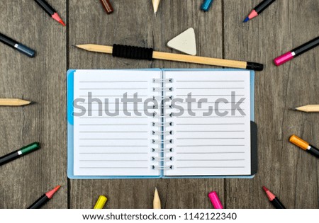 Back to school concept: pencils crayons and school supplies on a wooden background.

