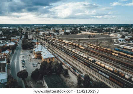 Cargo trains close-up. Aerial view of colorful freight trains on the railway station. Industrial conceptual scene with trains. Top view from flying drone