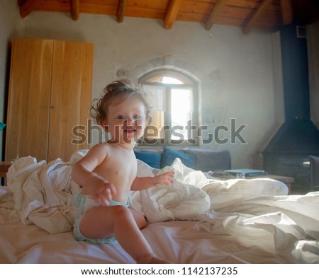Little baby boy in a bed in a morning time. Interior in Crete style, Greece