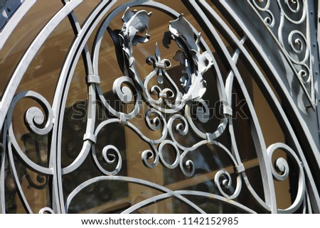Wrought iron decorative screen over a window.