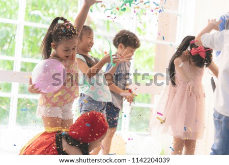 Kids are playing and throwing paper in kid party