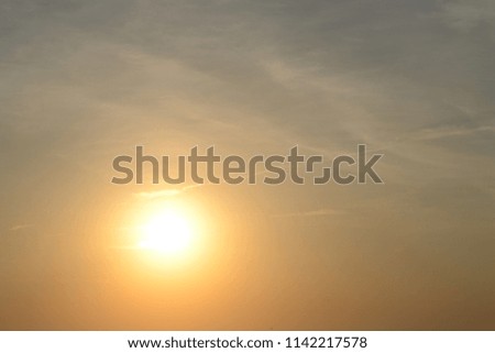 Sun at sunrise through fine clouds