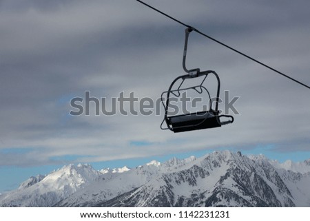 One cable chair over morning mountains. Alps,France