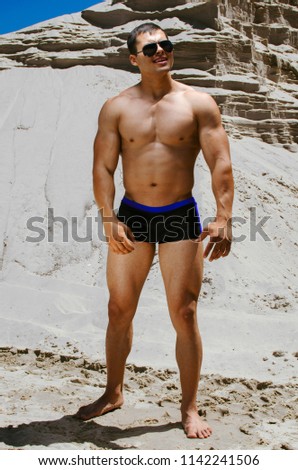 athletes on the beach, a fitness model posing in bikini.