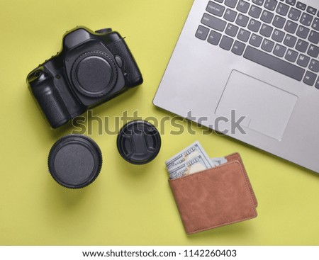 Equipment  photographer, laptop, purse with dollars on yellow background. Freelance concept, photographer's work, objects, top view, flat lay
