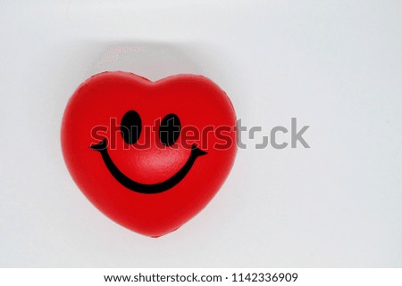 a happy lovely red heart with smile face isolated on white background.