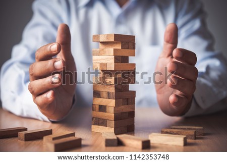 Business risks in the business. Requires planning Meditation must be careful in deciding to reduce the risk in the business. As the game drew to a wooden block from the tower Royalty-Free Stock Photo #1142353748