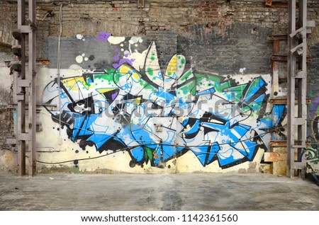 Street art. Abstract background image of a full completed graffiti painting in chrome and blue tones Royalty-Free Stock Photo #1142361560