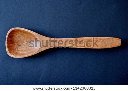 A studio photo of a wooden spoon