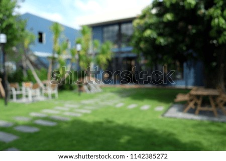 Blurred leisure corner with wood chairs and table outdoor green natural background