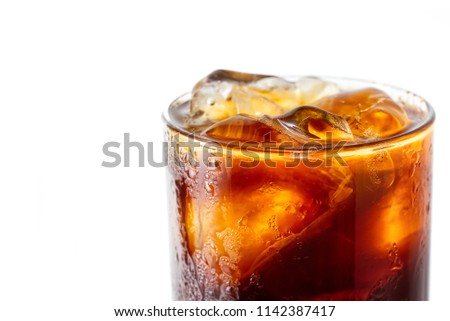 Blow your mind with close up macro photo of brew coffee Americano with ice in glass isolated on white background. Water drop on Americano glass make it look cold and refreshing to make you thirsty. Royalty-Free Stock Photo #1142387417