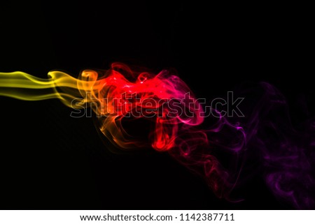 Multicolour smoke on black background