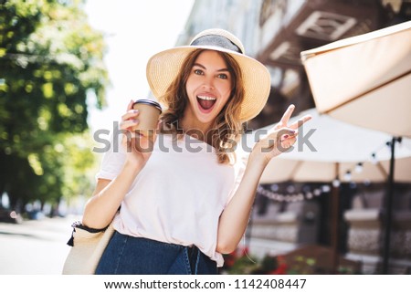 Smiling with teeth, cute woman taking photo in the morning on her holidays. She go to her friends and looking for good time together
