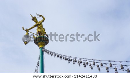 View image light pole on the road in City with fairy tale Statue