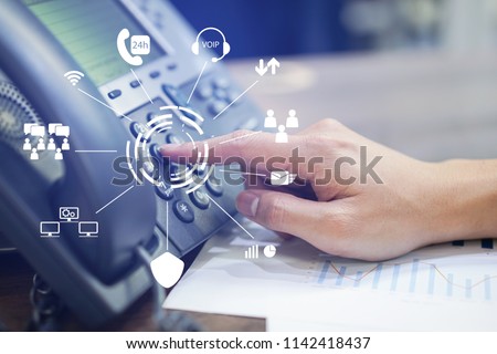 close up employee call center man hand point to press button number on telephone office desk with virtual communication technology concept Royalty-Free Stock Photo #1142418437