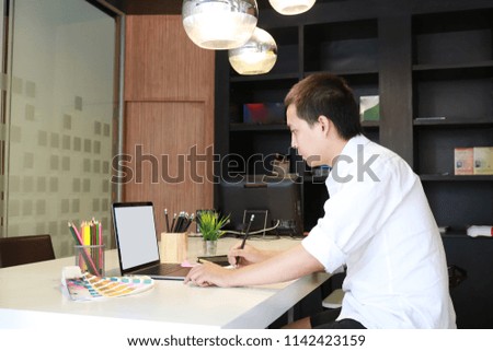 Businessman using credit card and laptop at home office