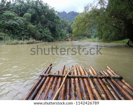 Bamboo raft floating in the river Royalty-Free Stock Photo #1142426789