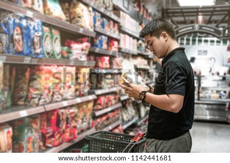 Asian man choosing instant noodle in supermarket, Steward shopping alone at supermarket, Choosing food in market, Shopping alone in food store, Dried food in supermarket, Market in shopping mall