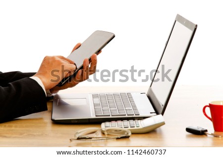 Business man hand using tablet device with laptop compter on woode table work office on white backgrounds