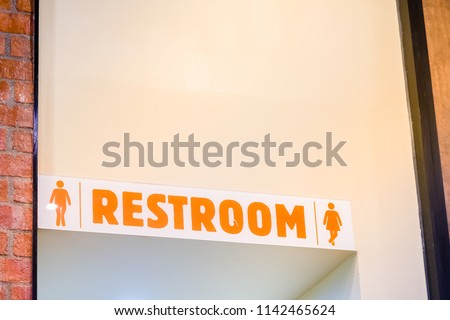 man and woman use toilet after delicious meal in fast food.clean lavatory in restaurant.acrylic toilet restroom sign in coffee shop cafe.male and female washing hands in restroom.toilet symbol.